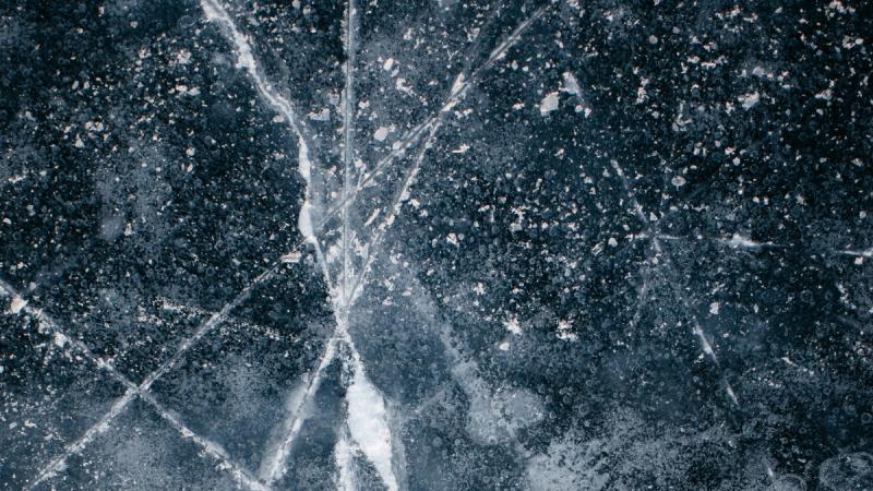 Flecks of white on dark blue marble.