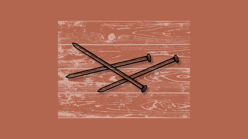 Three metal nails on a white wood etching over a brown backdrop.